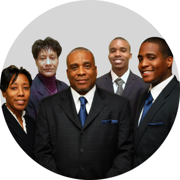 Five business professionals in suits posed in front of a gray background.
