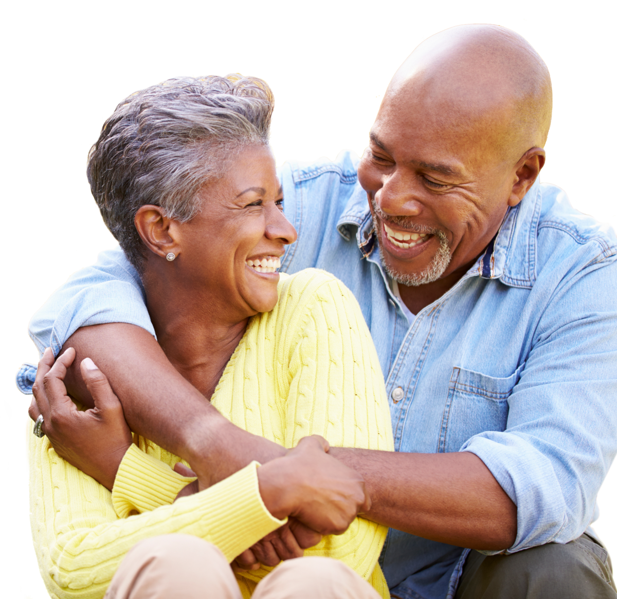 Two smiling people hugging and laughing together in bright casual clothes