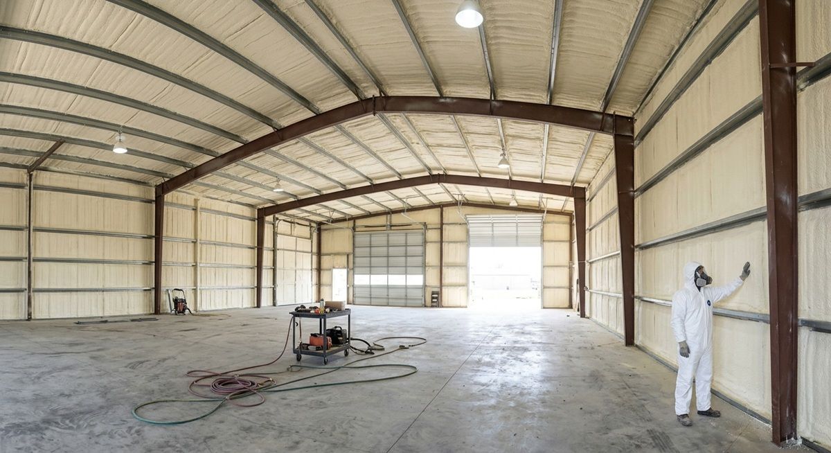 Spray foam insulation inside a metal workshop.
