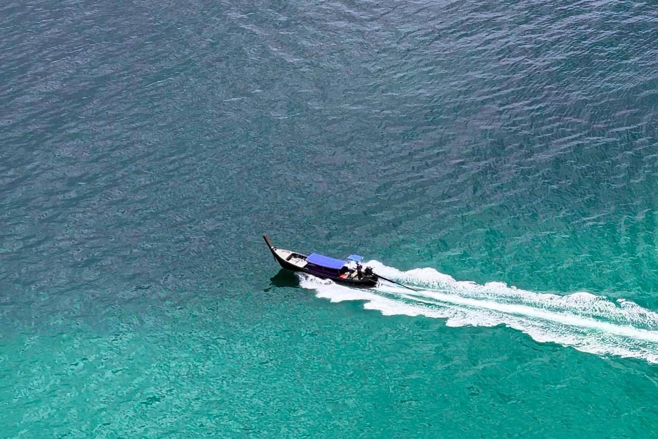 A boat is floating on top of a body of water.