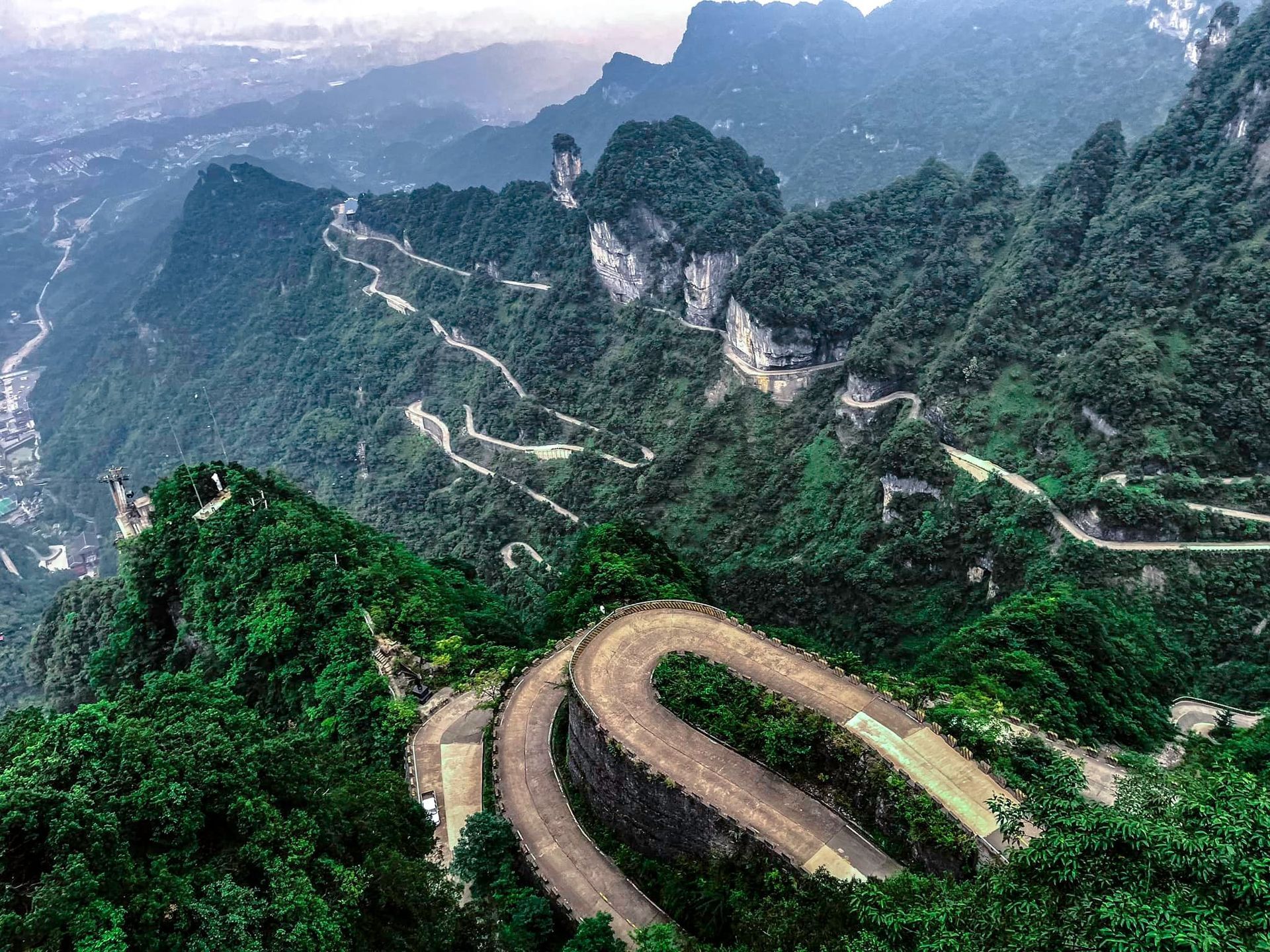 An aerial view of a winding road in the mountains.