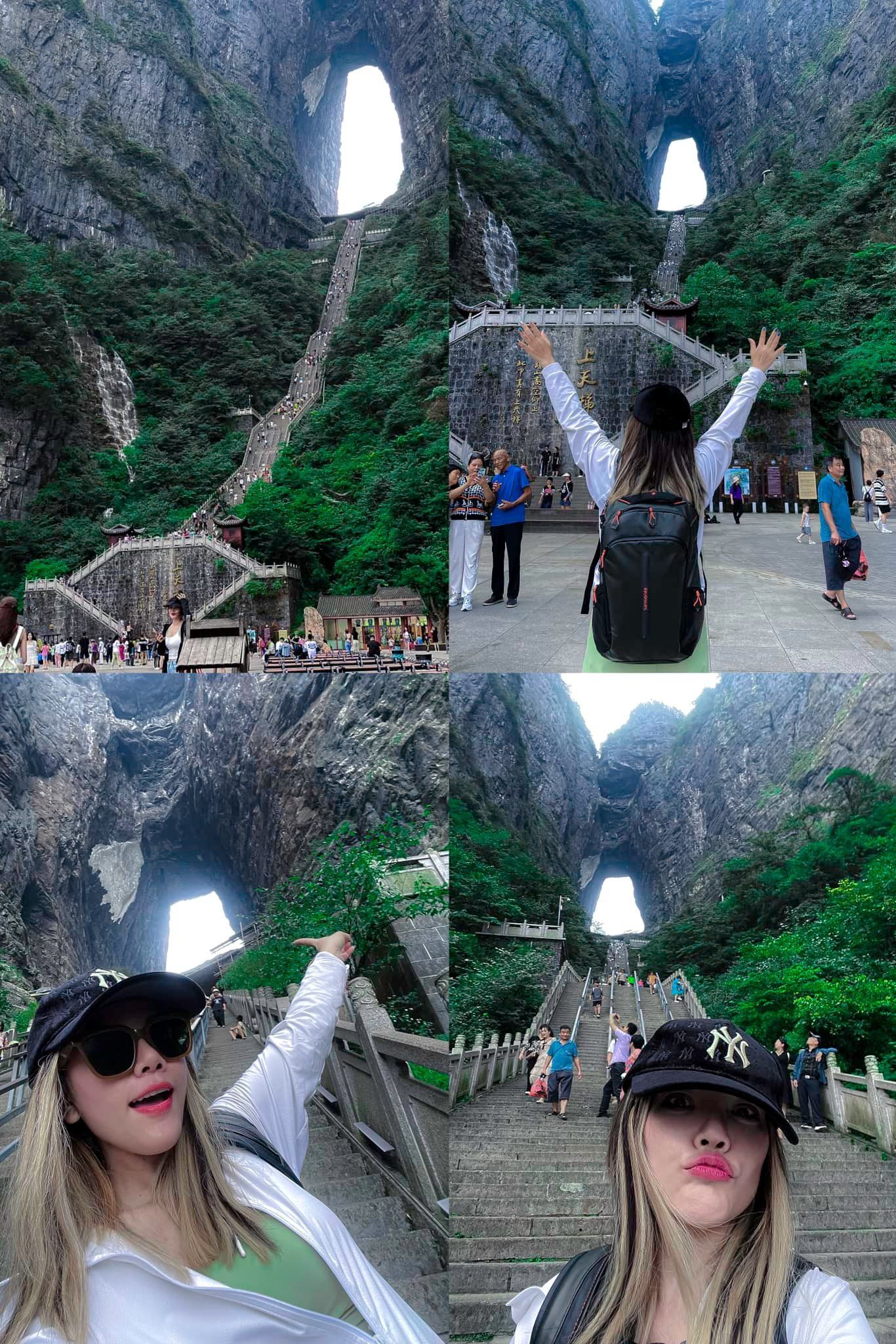 A woman is taking a selfie in front of a waterfall.