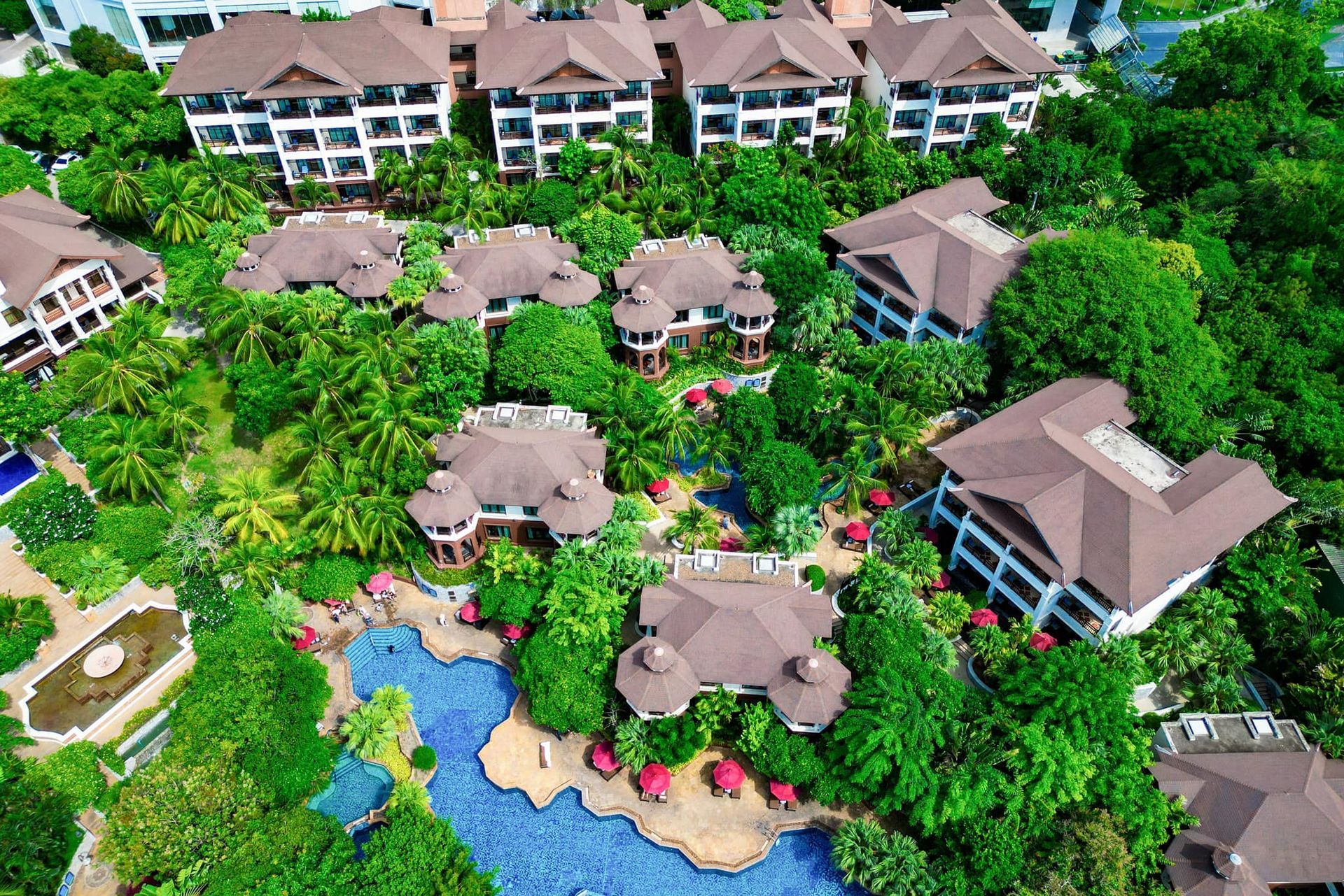 An aerial view of a resort with lots of trees and buildings