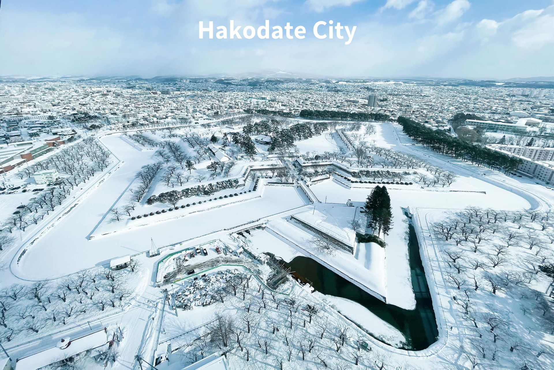 An aerial view of a city covered in snow.