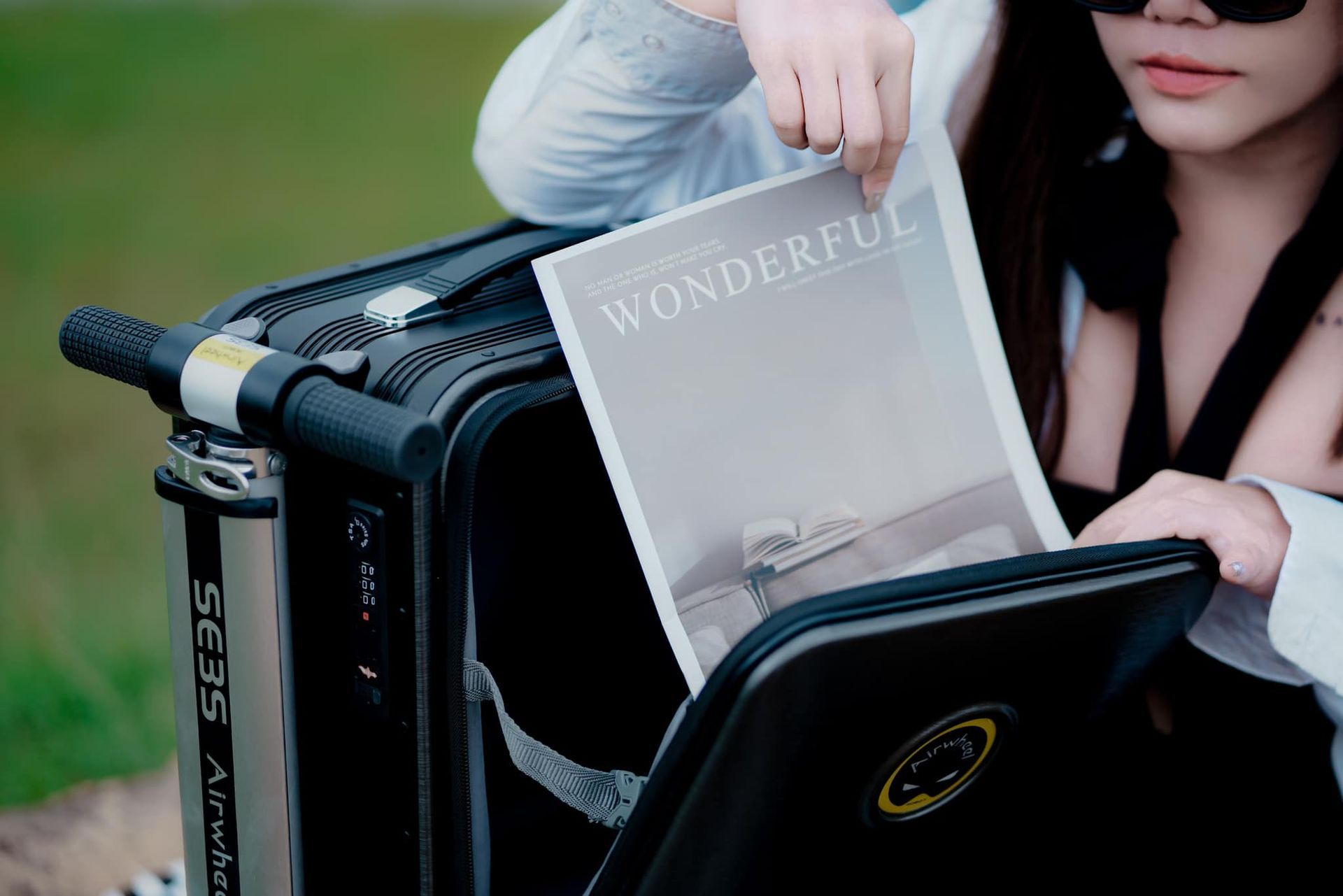 A woman is holding a magazine that says wonderful.