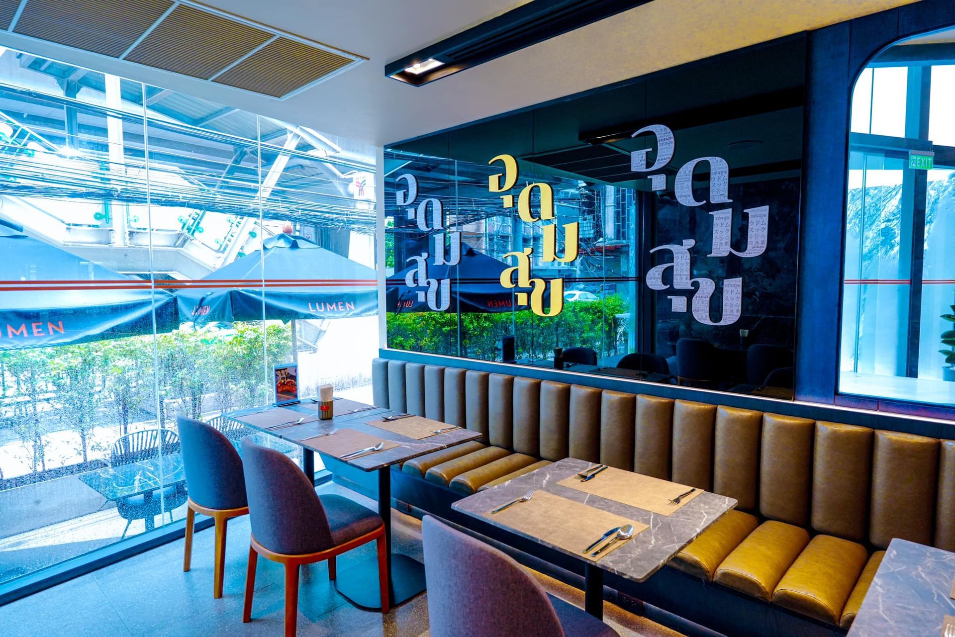 A restaurant with tables and chairs and a large window.