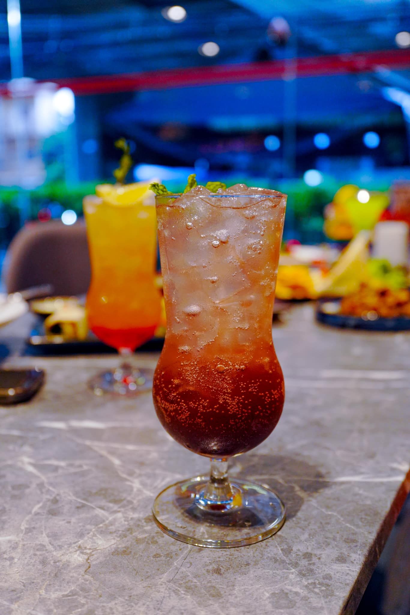 A close up of a drink in a glass on a table.