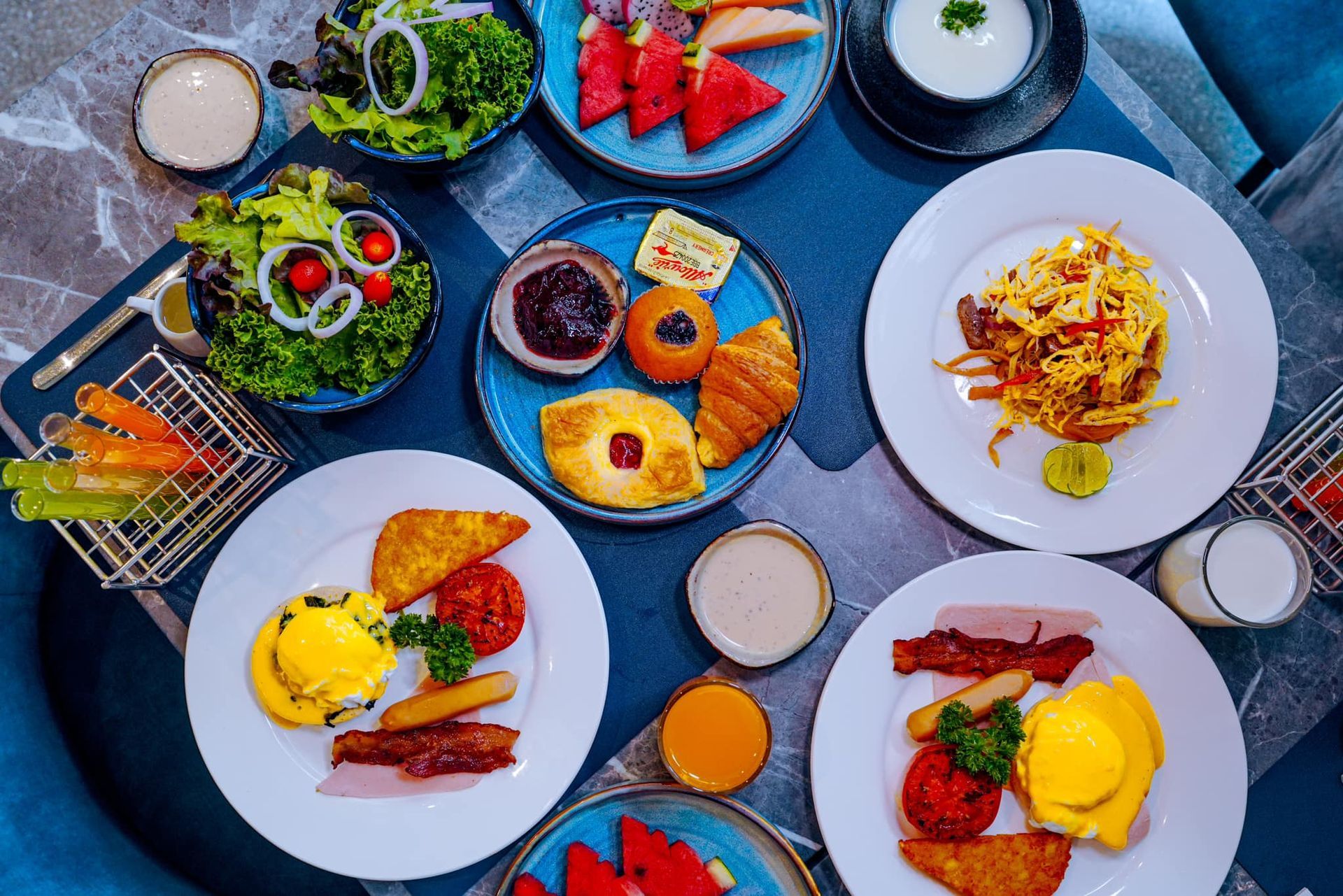 A table topped with plates of food and fruit.
