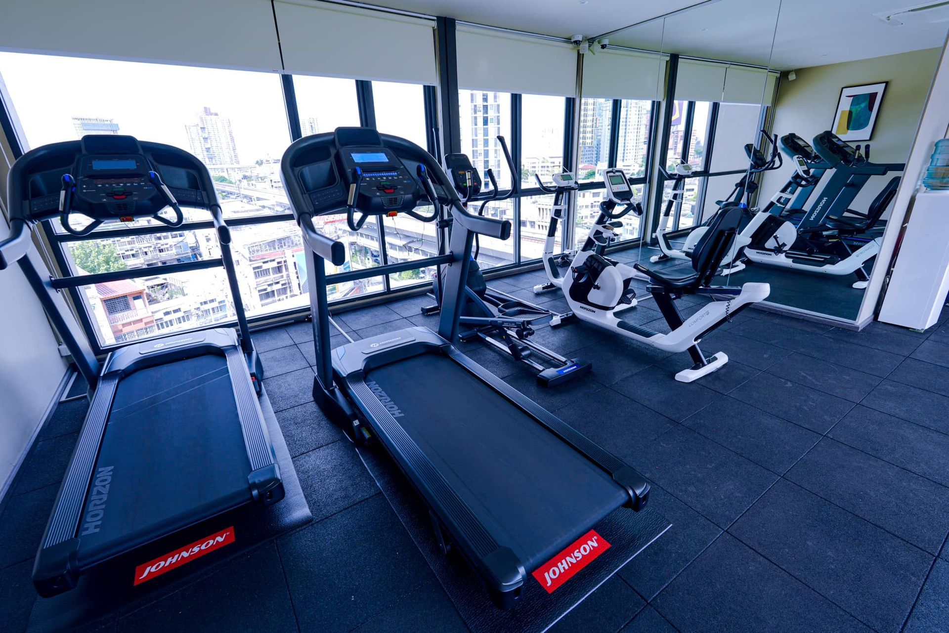 A gym with a lot of treadmills and exercise bikes