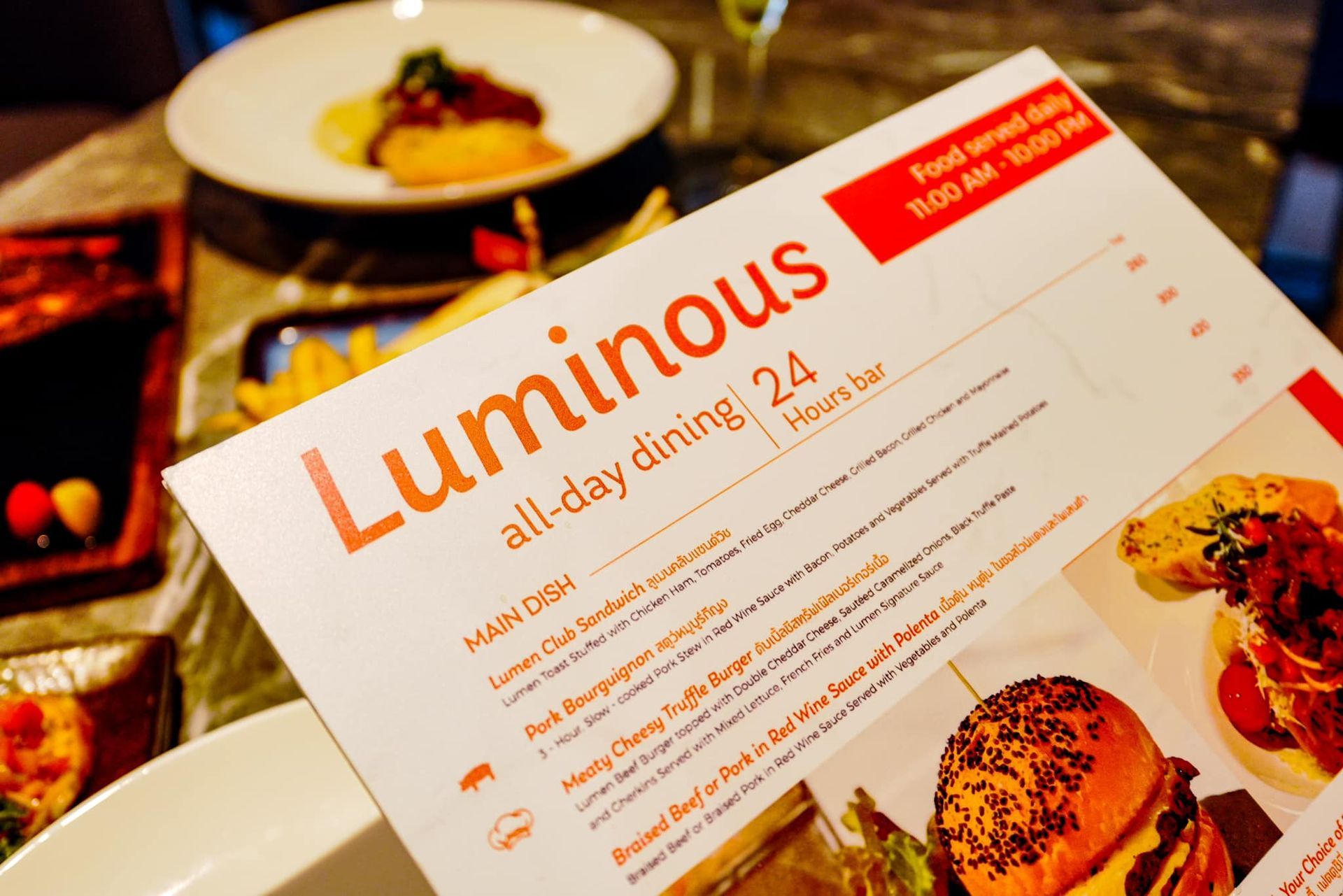 A menu for luminous all day dining is on a table
