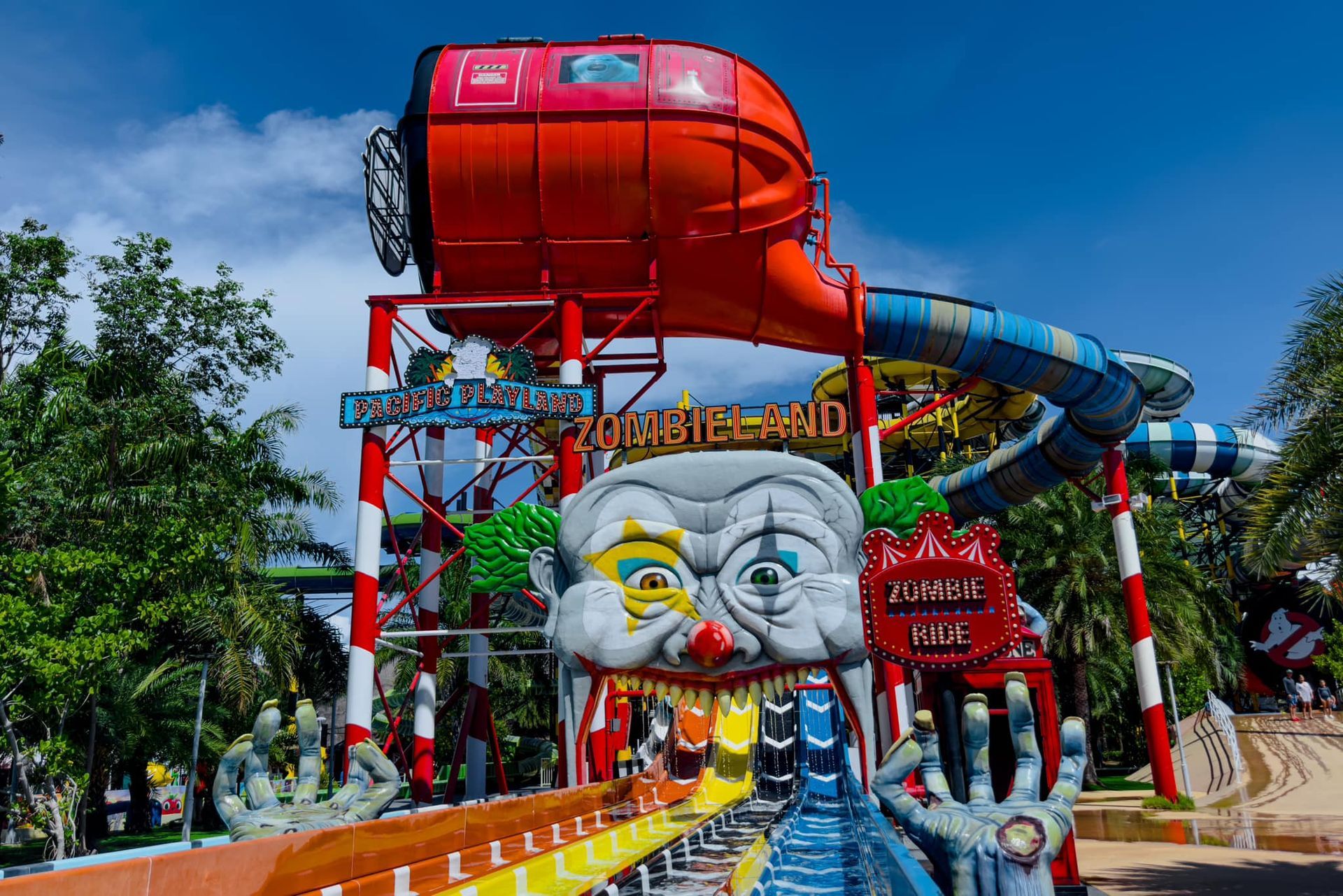A water slide at a water park with a clown face on it.