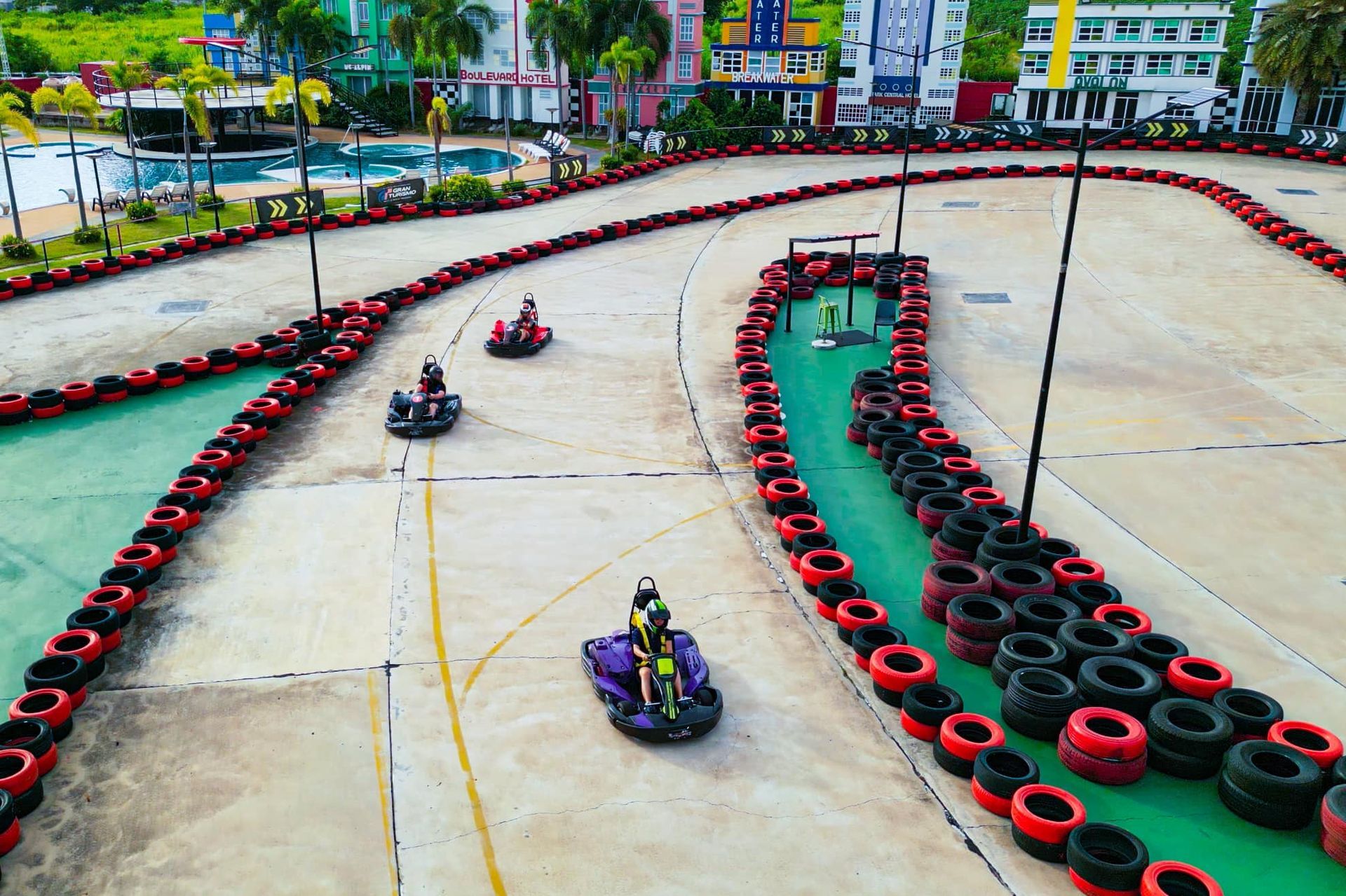 A group of people are riding go karts on a track.
