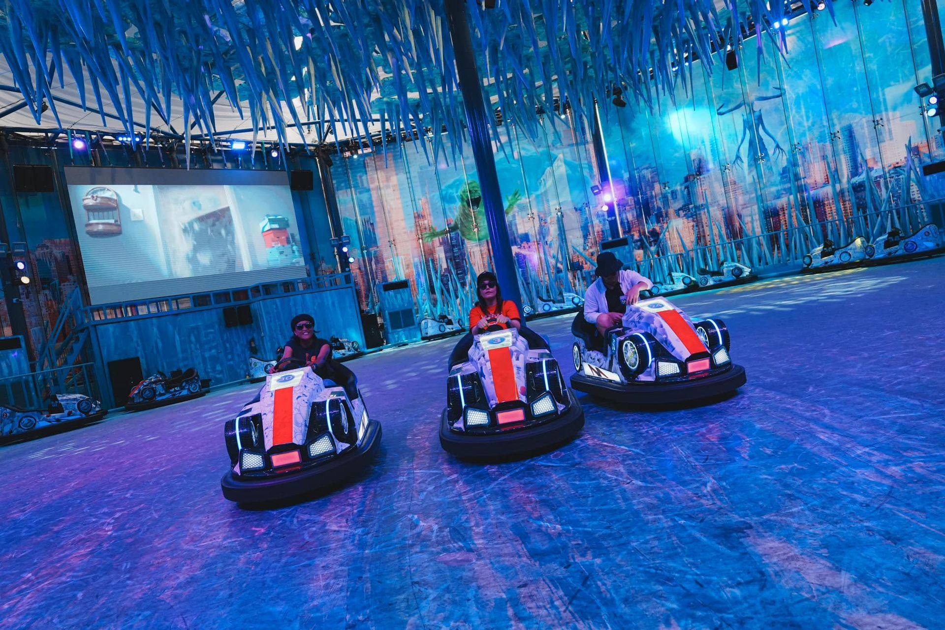 A group of people are riding go karts on a track.