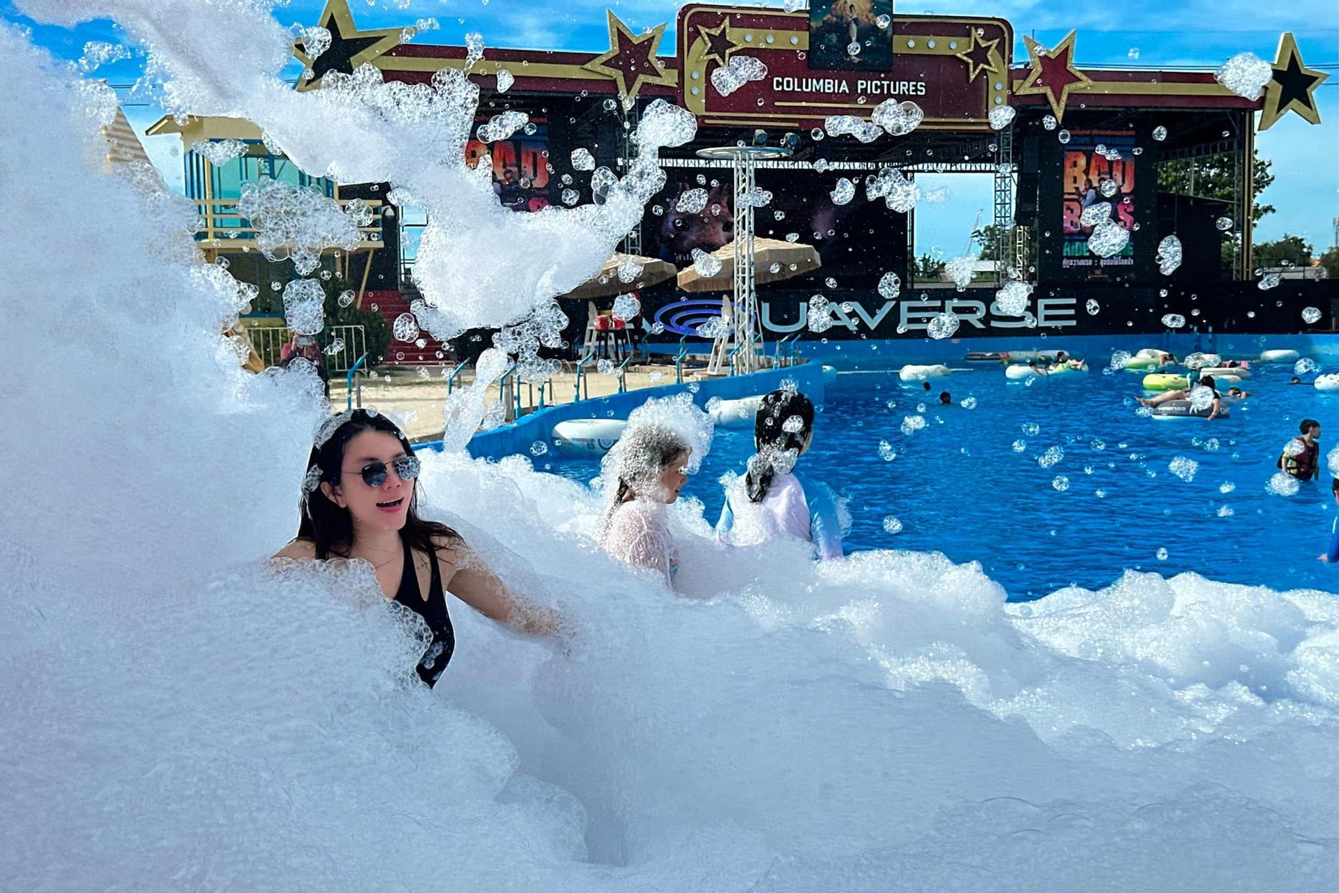 A woman is standing in a pool of foam.