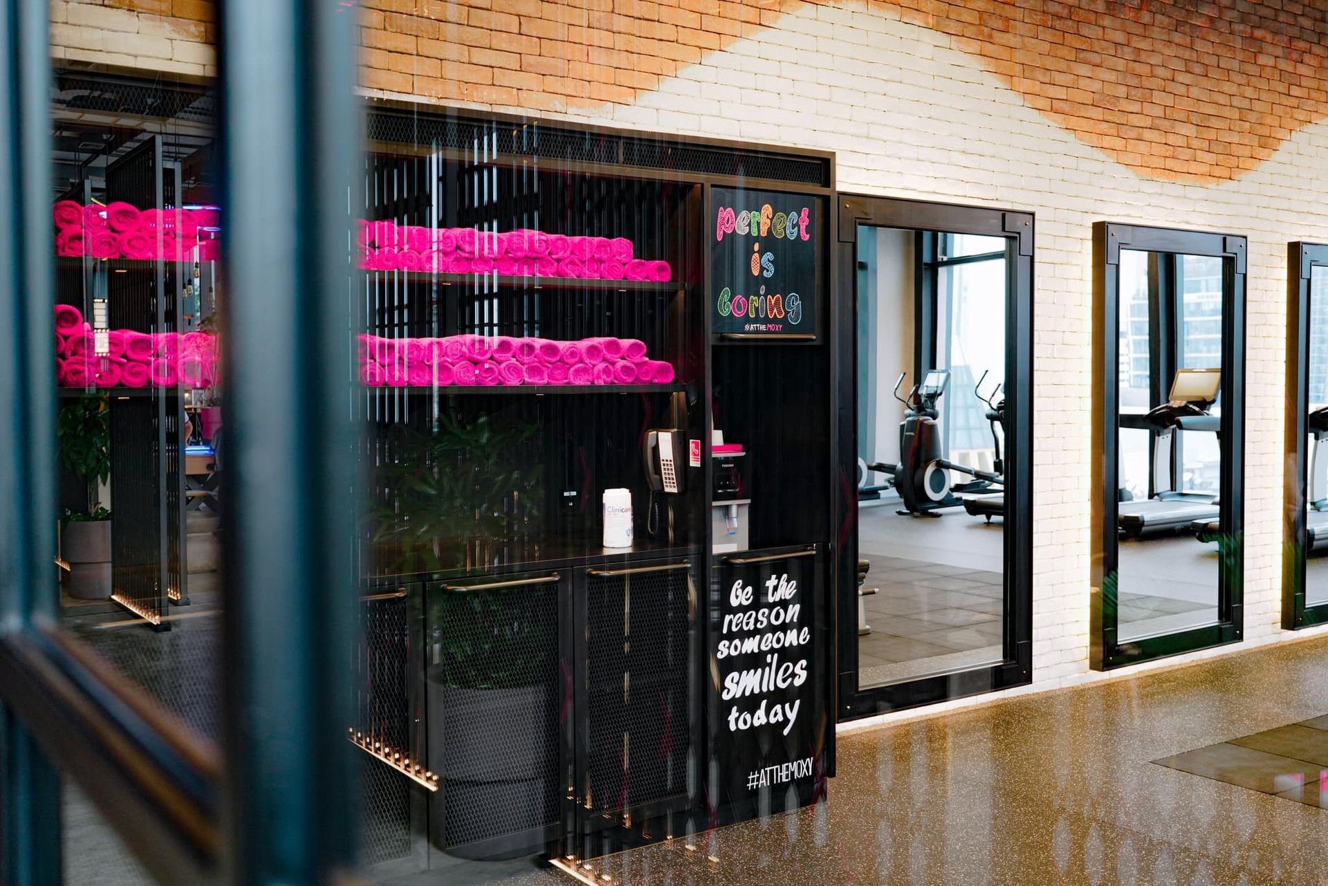 A gym with a sign in front of it and a fence.