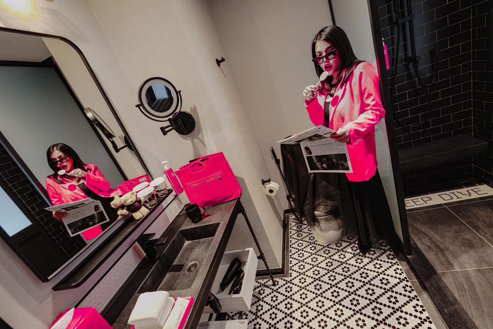 A woman is brushing her teeth in front of a mirror in a bathroom.