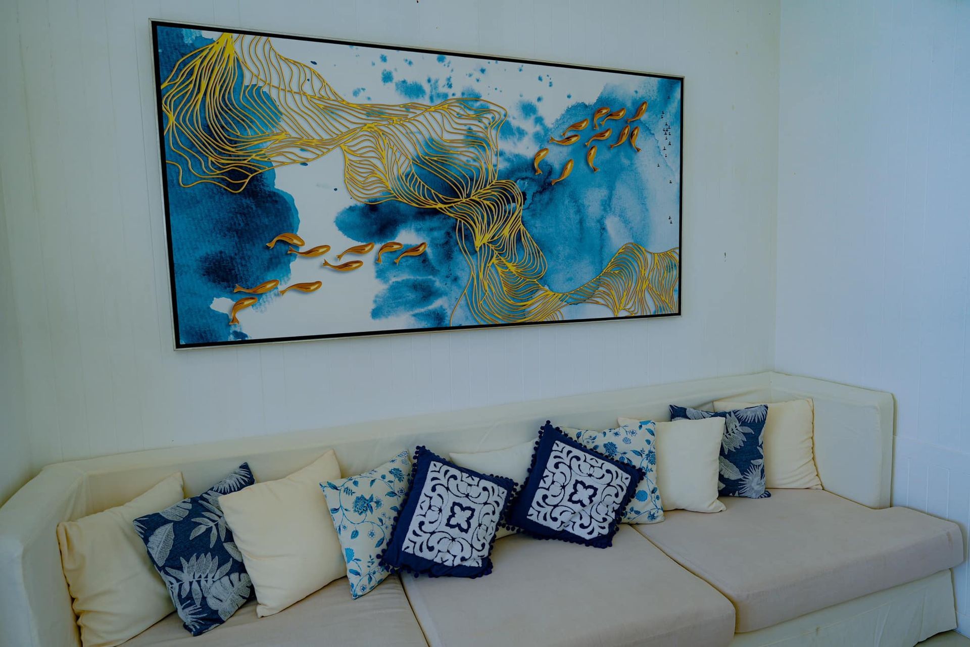 A living room with a couch and a painting on the wall