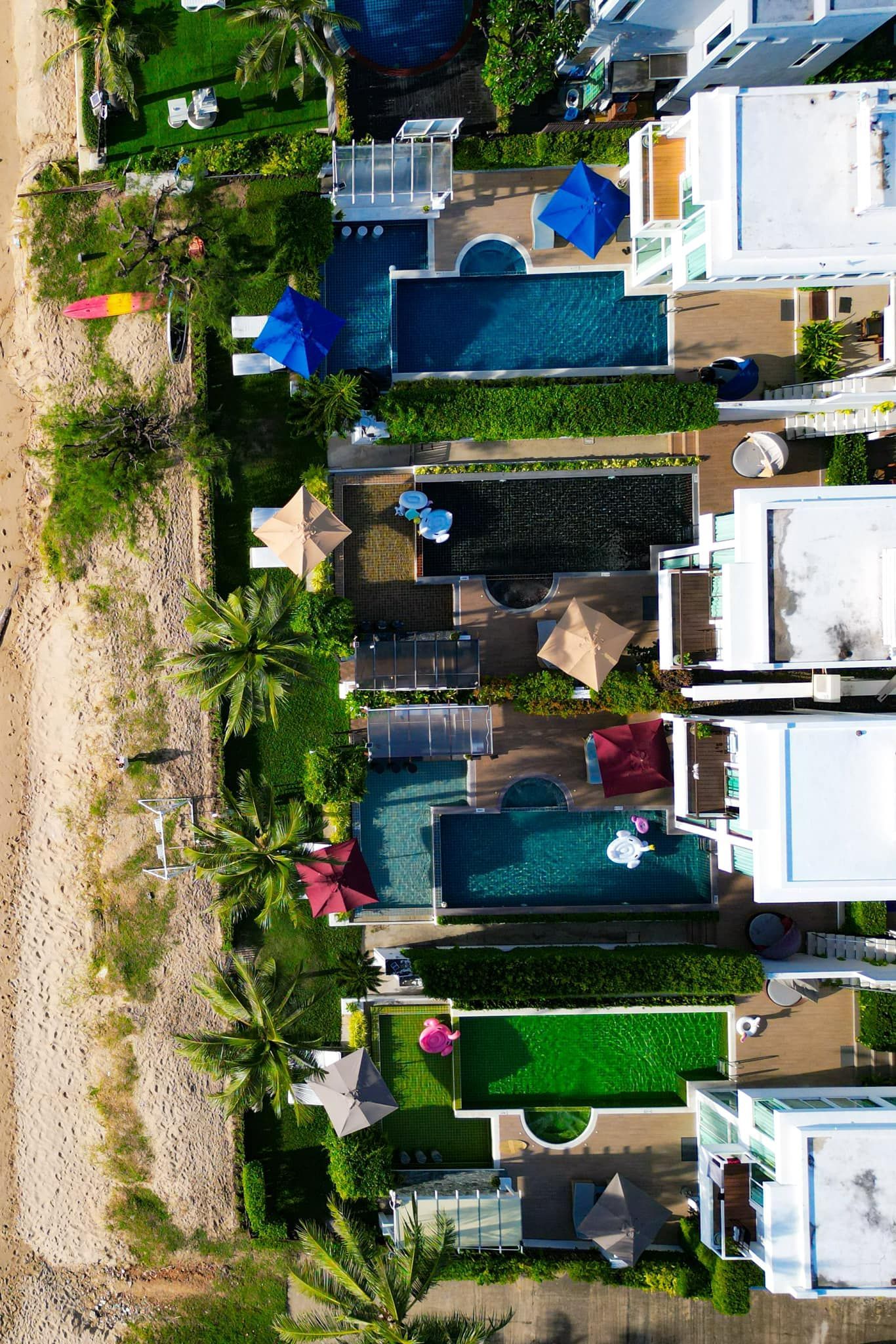 An aerial view of a row of houses next to a beach.
