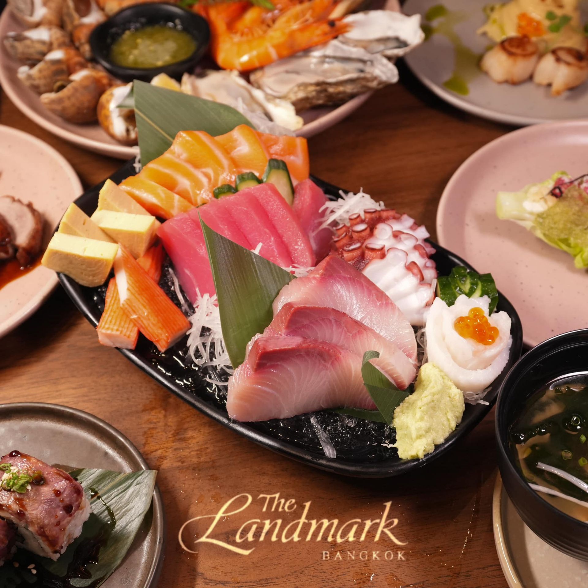 Sushi and Sashimi are on a table at the landmark bangkok