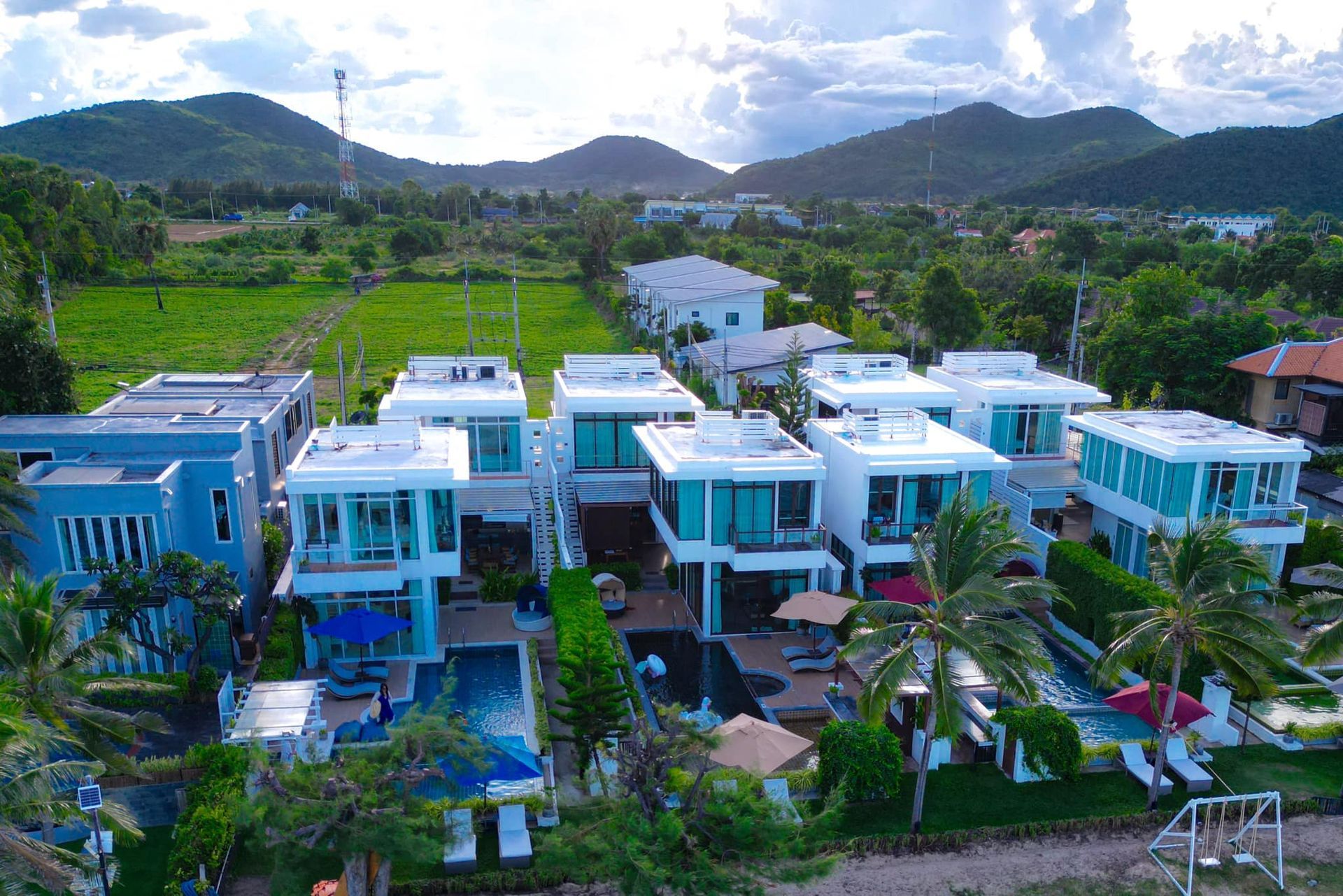An aerial view of a row of houses with mountains in the background.