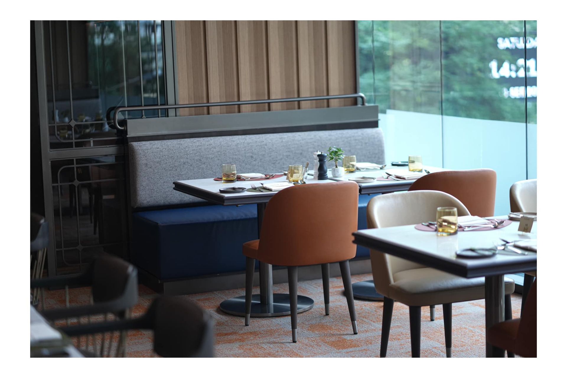 Atrium Restaurant with tables and chairs and a large window.