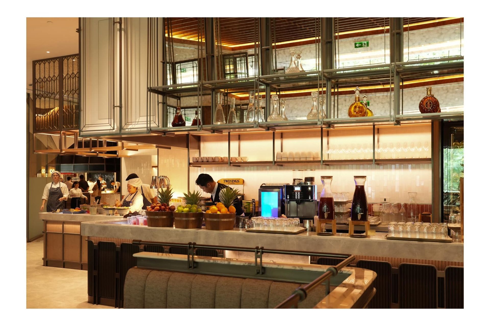 A restaurant with a long counter and a lot of food on it.