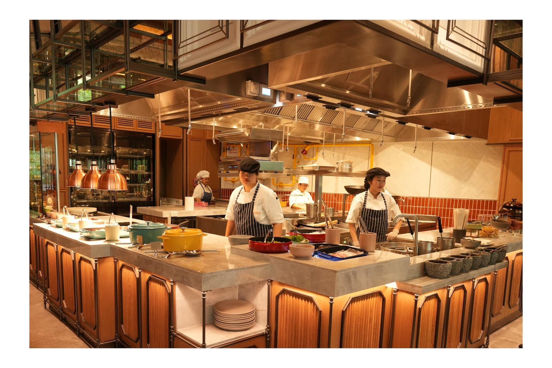 A group of chefs are working in a large kitchen.