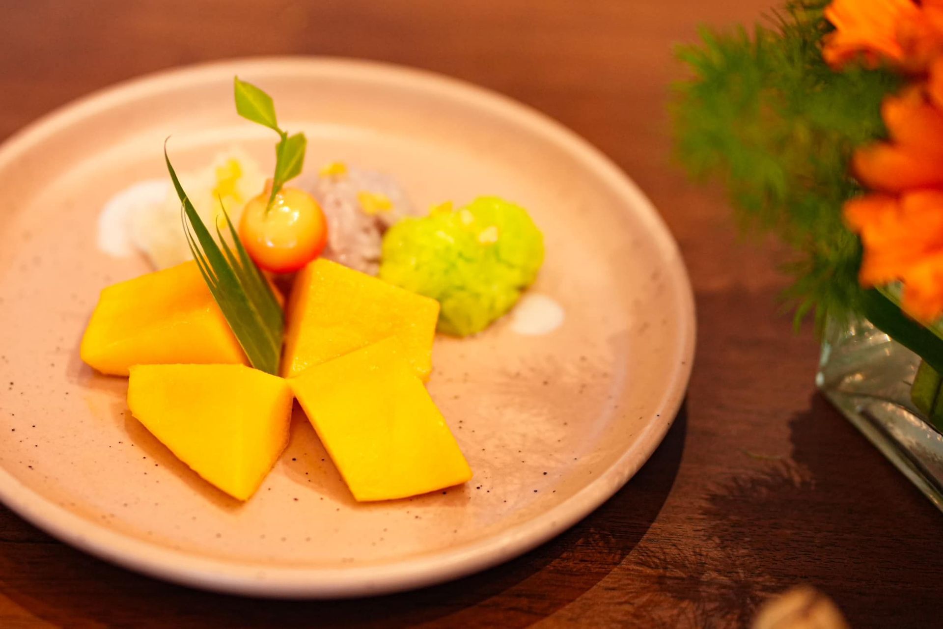 A close up of a mango and sticky rice on a table.