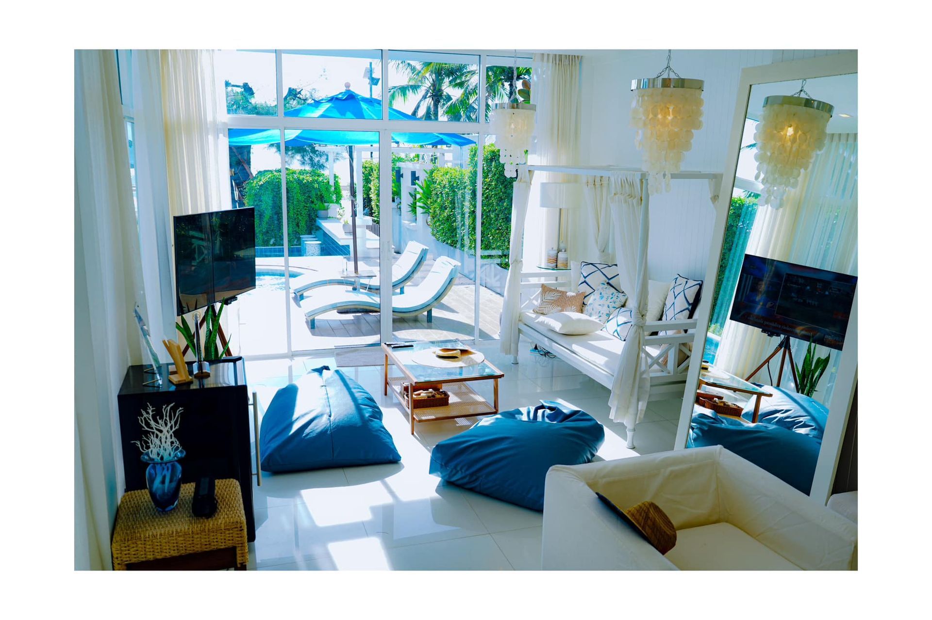 A living room with a couch , chairs , and a television.