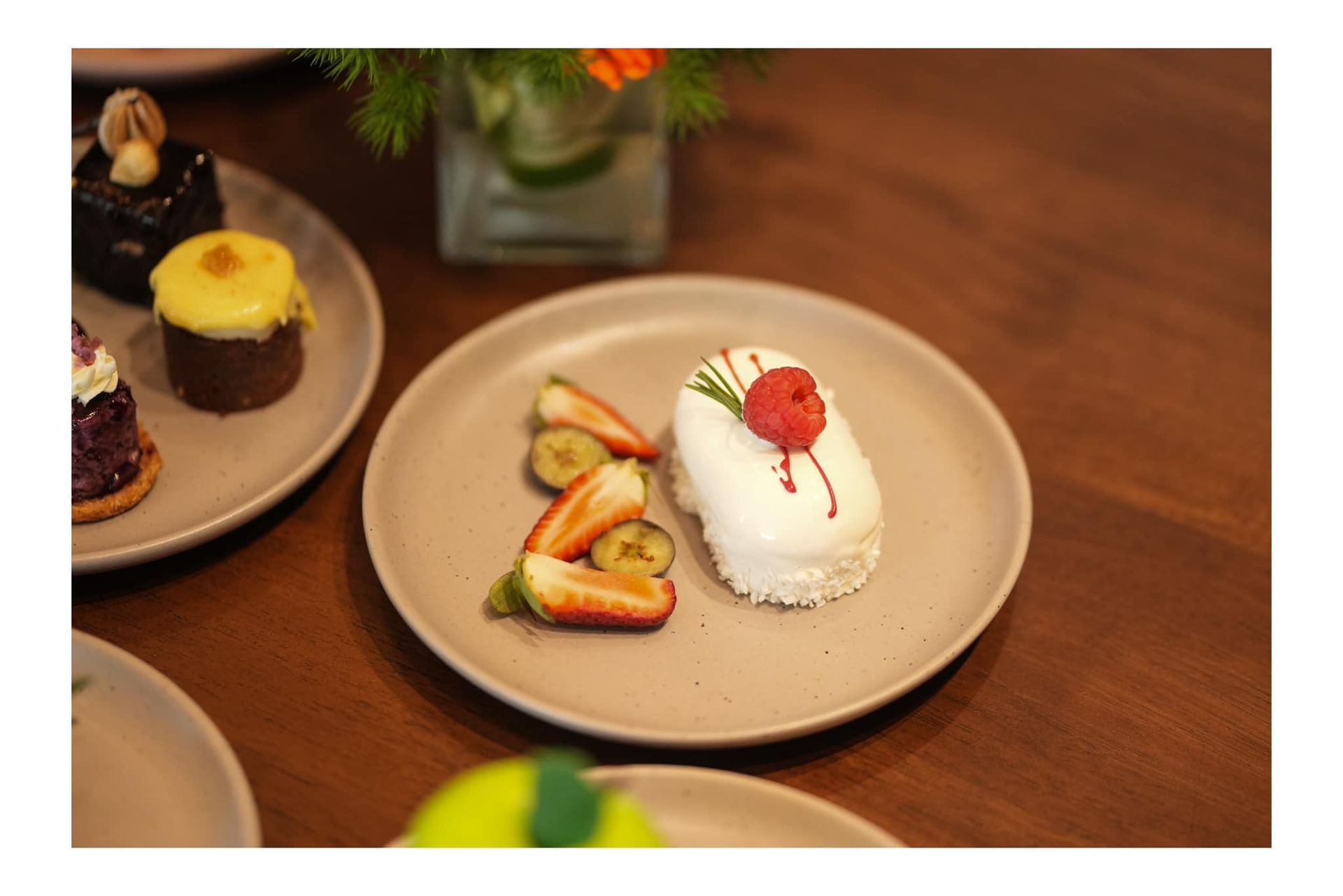 A plate of dessert with strawberries and bananas on a wooden table.
