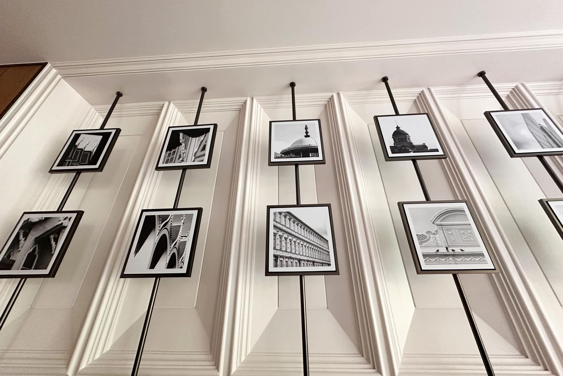 A row of black and white pictures hanging on a wall