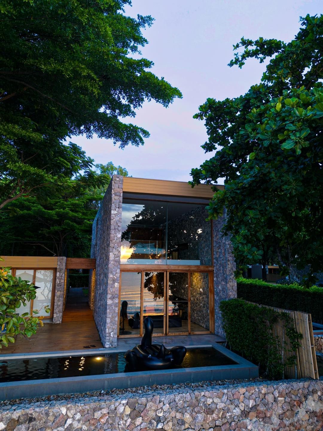 A house with a lot of windows and trees in the background