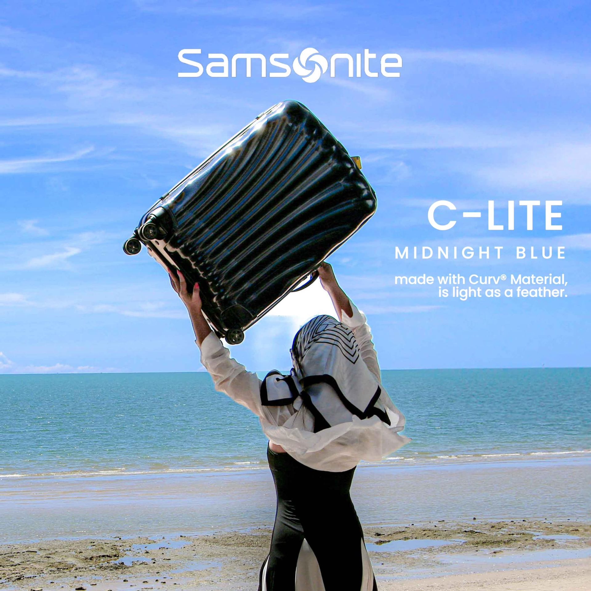 A samsonite c-lite midnight blue suitcase is being held over someone 's head
