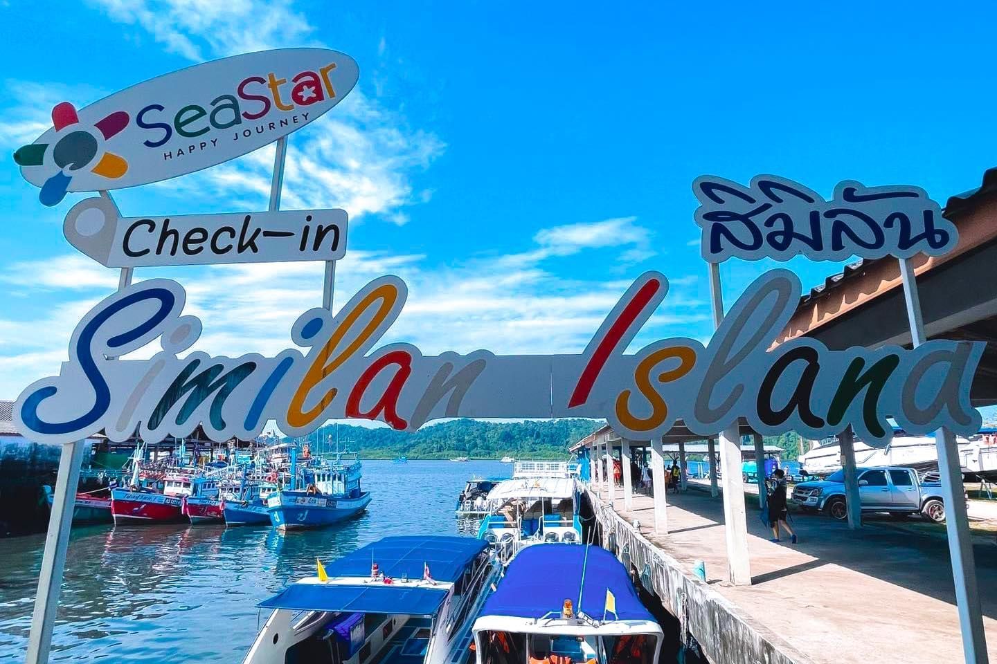 A sign that says check in similan island on it