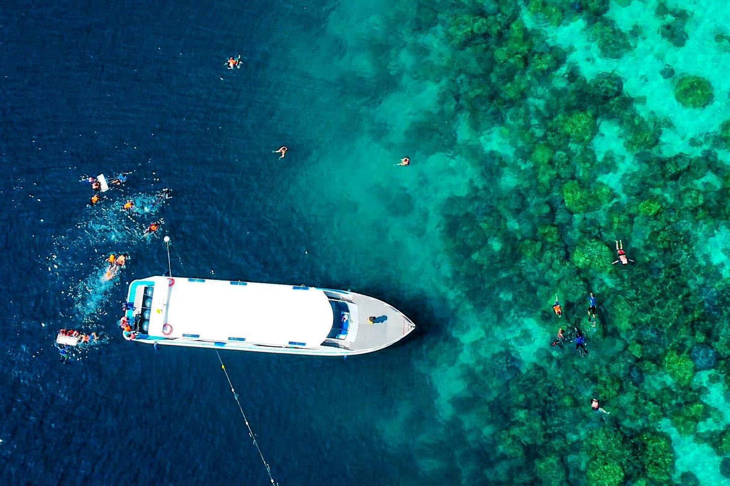 An aerial view of a boat in the ocean near Surin Islands