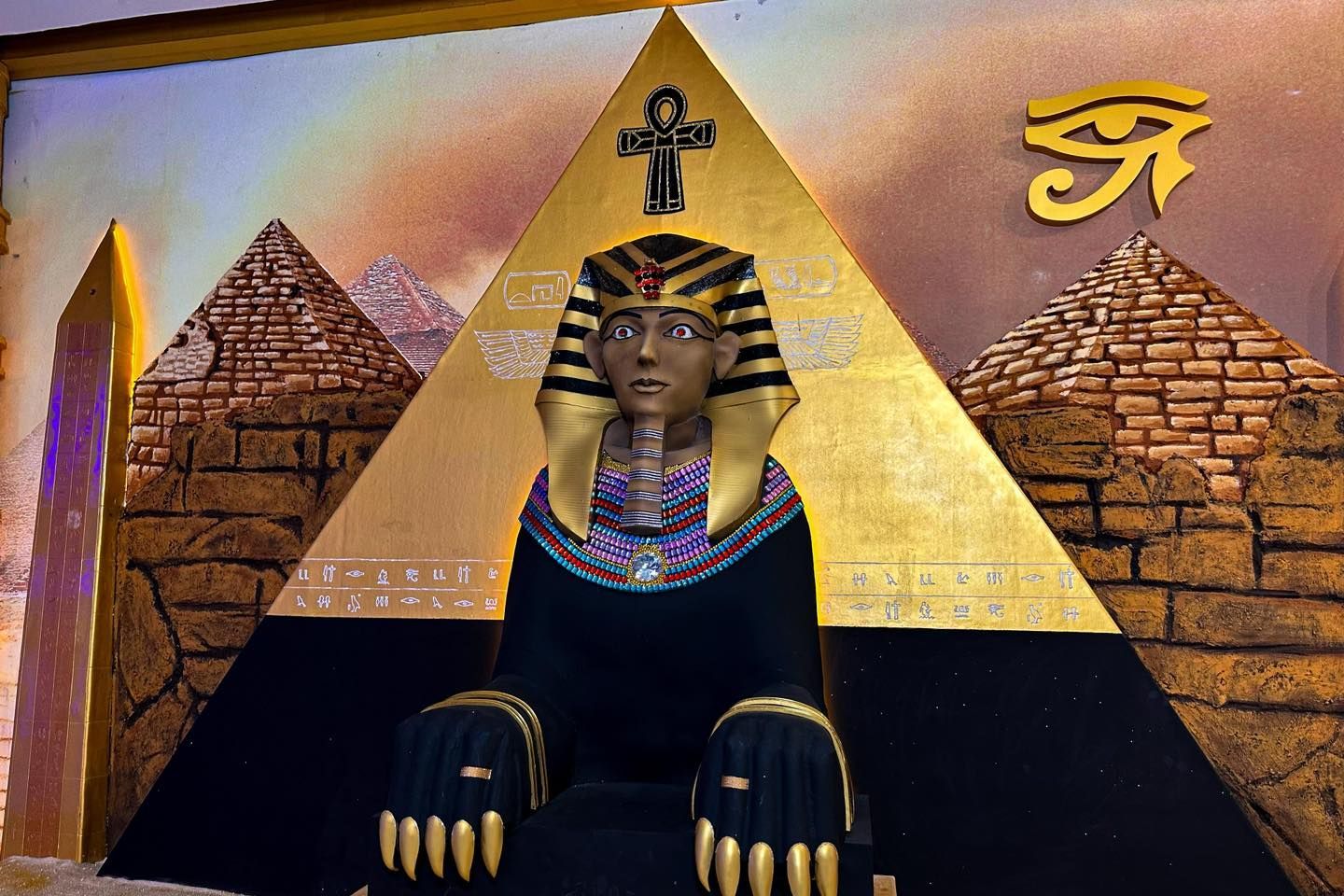 A statue of a sphinx sitting on top of a pyramid