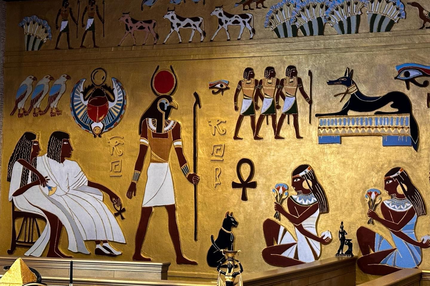 A painting of ancient egyptian people and animals on a wall