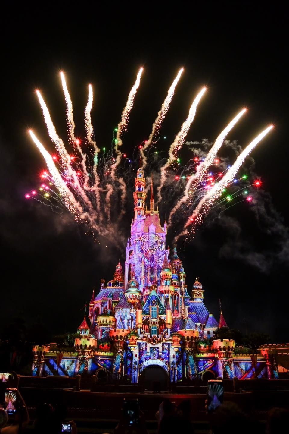 A fireworks display over a castle at night