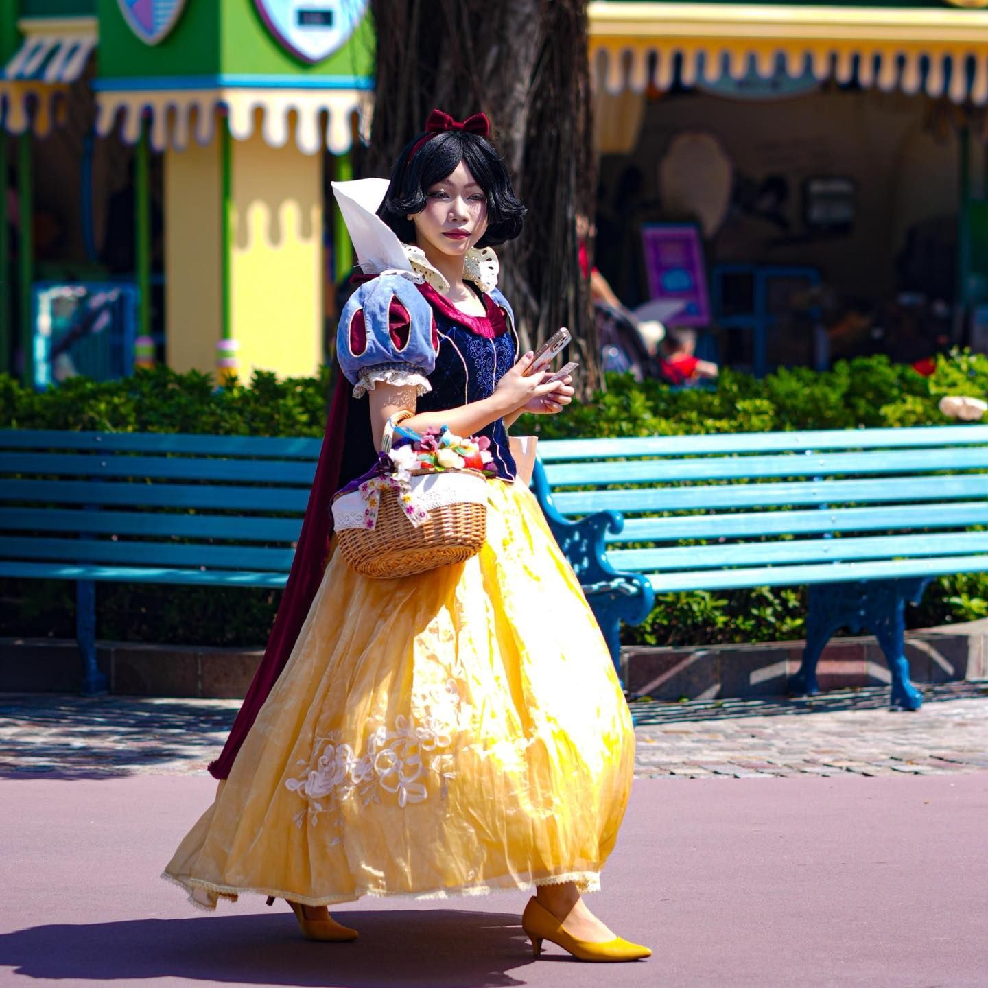 A woman dressed as snow white is walking down the street