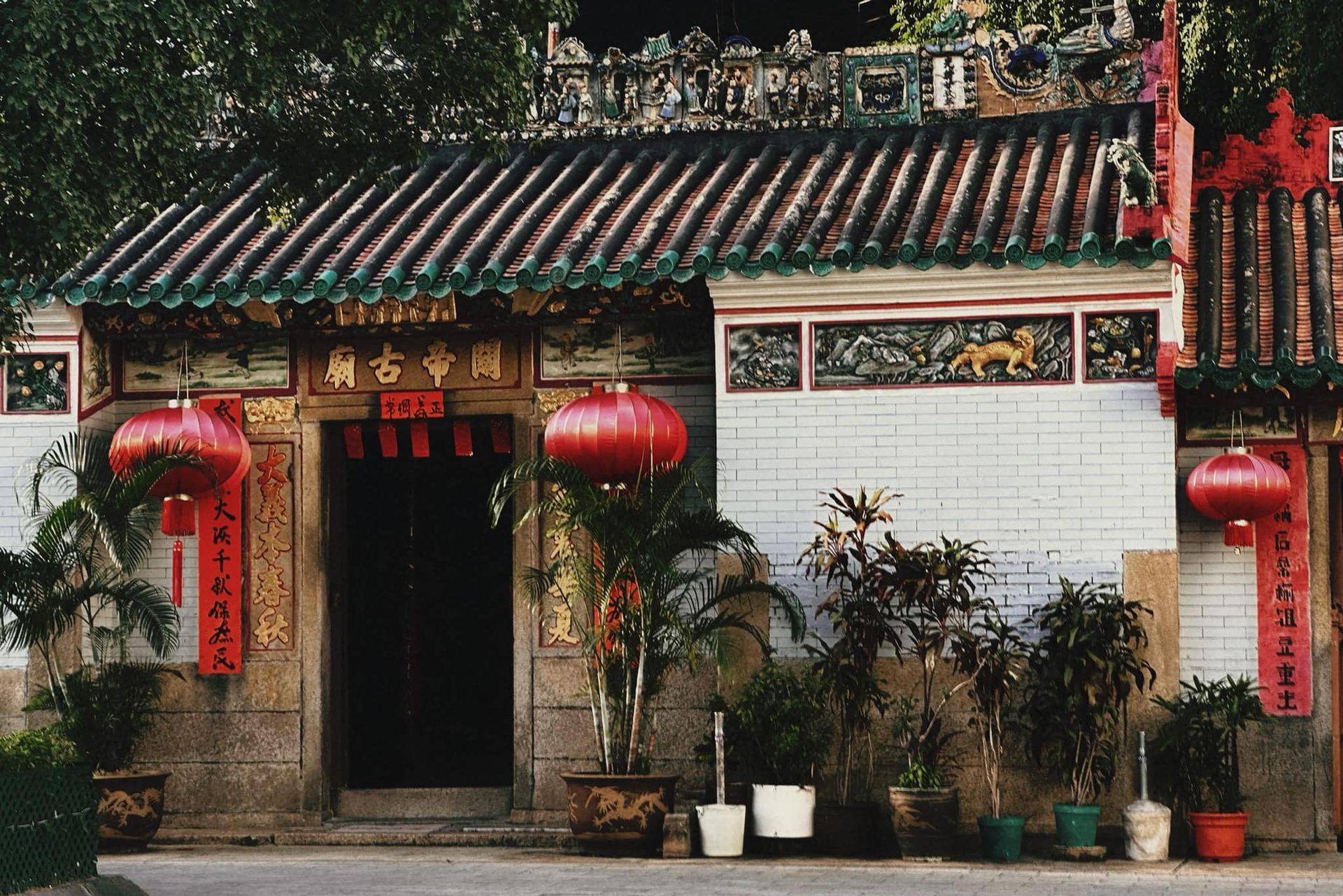 A Taiwanese building with red lanterns and potted plants