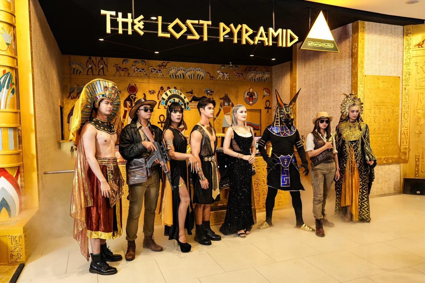 A group of people standing in front of a sign that says the lost pyramid