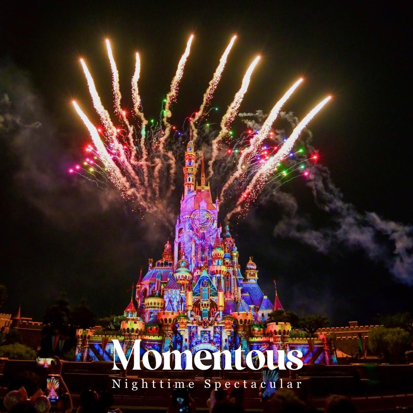 A castle is lit up with fireworks and the words momentous nighttime spectacular