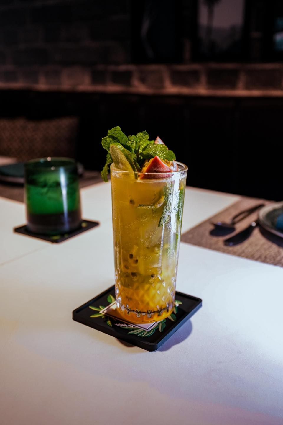 A close up of a drink in a glass on a table.