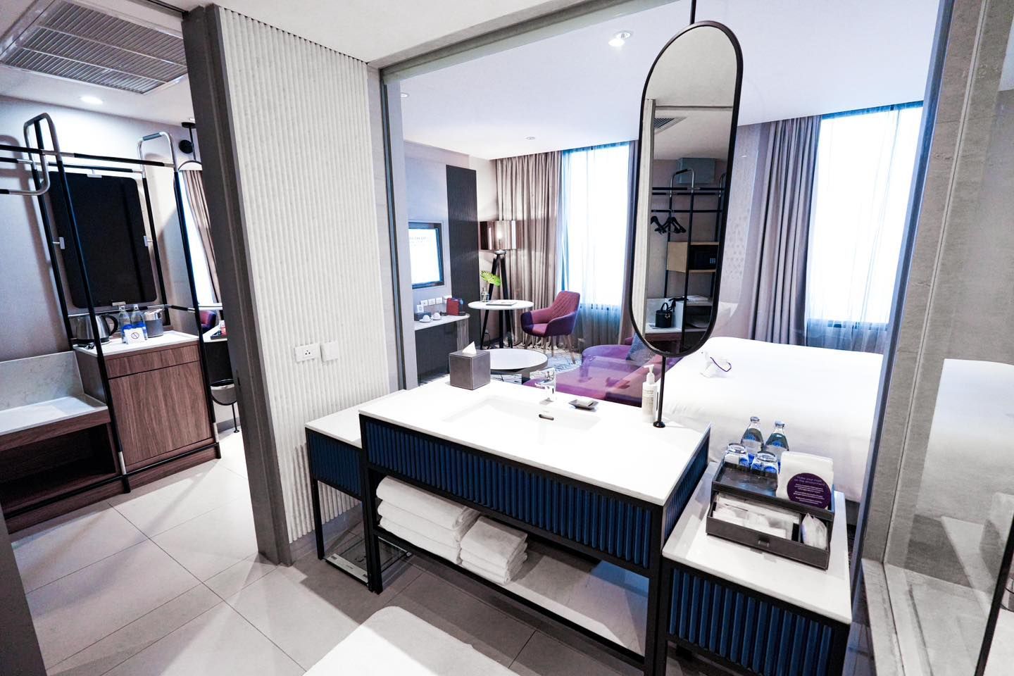A hotel room with a sink and a mirror in Avani Sukhumvit Bangkok