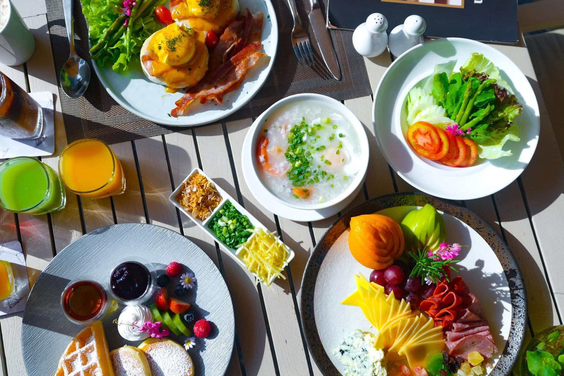 A table topped with plates of food and drinks.