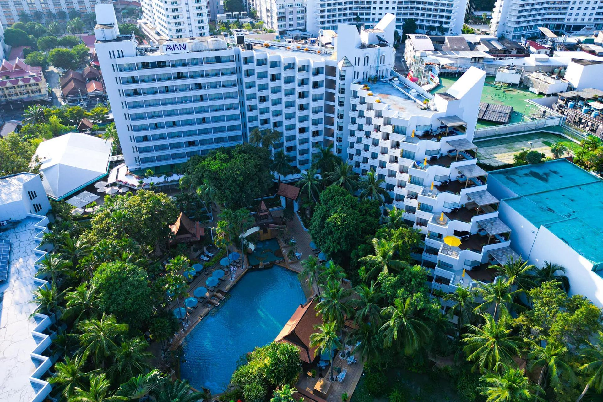 An aerial view of a Avani Hotel with a pool in front of it in Pattaya