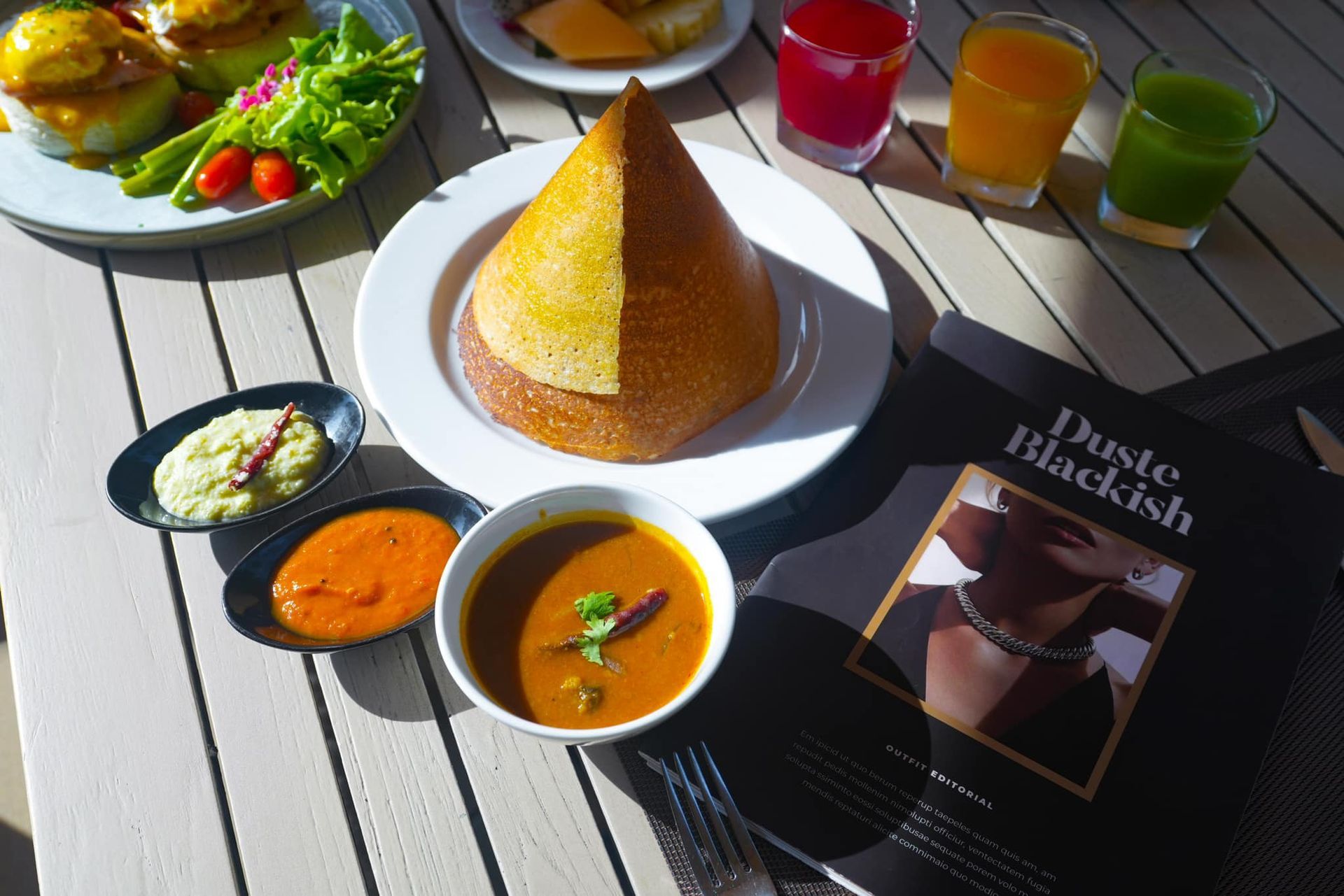A table topped with plates of food and a book titled dirty blackish