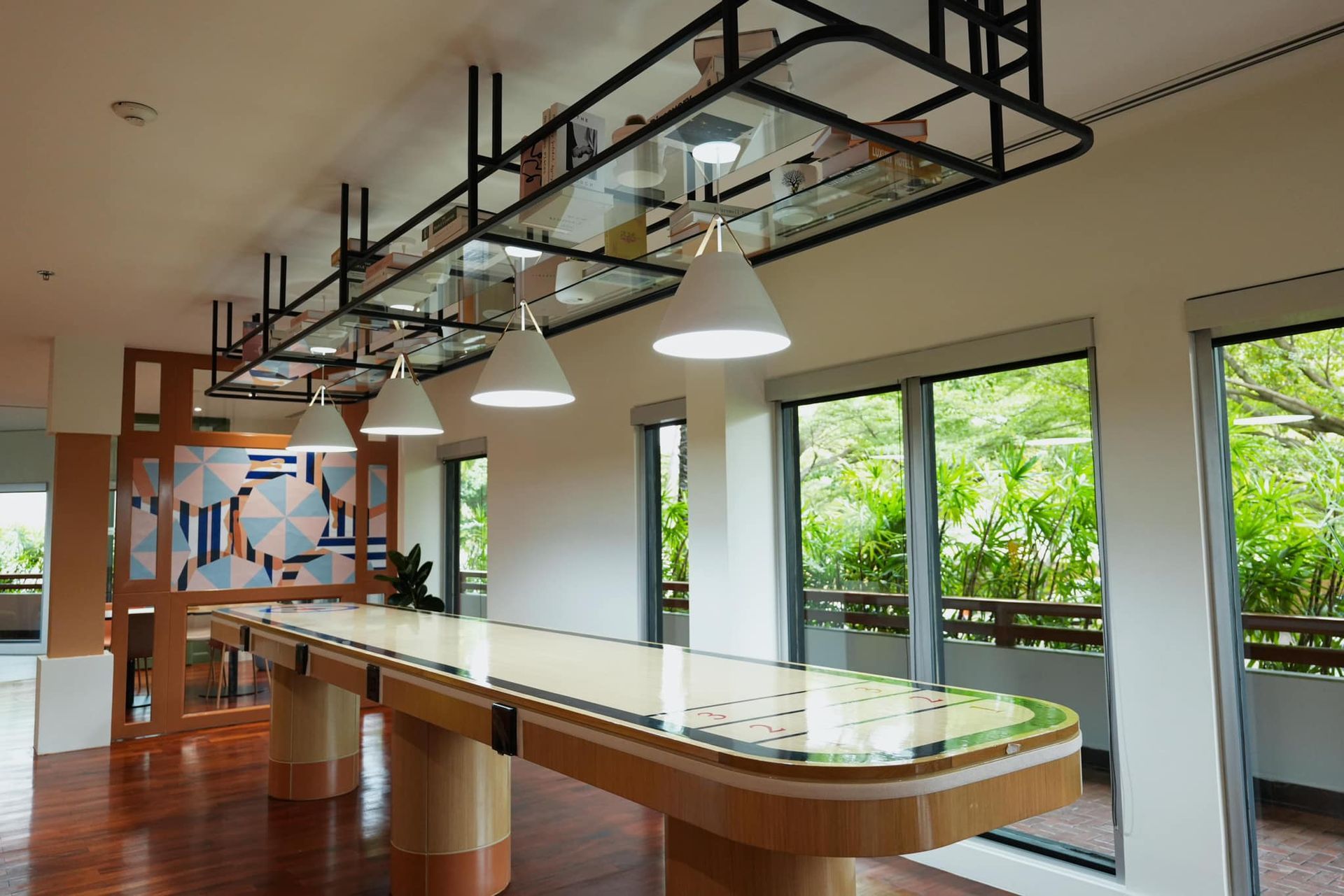 A long table in a room with a lot of windows