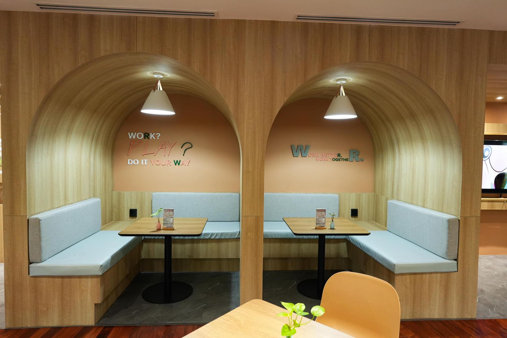 A dining area with tables and benches in a building.