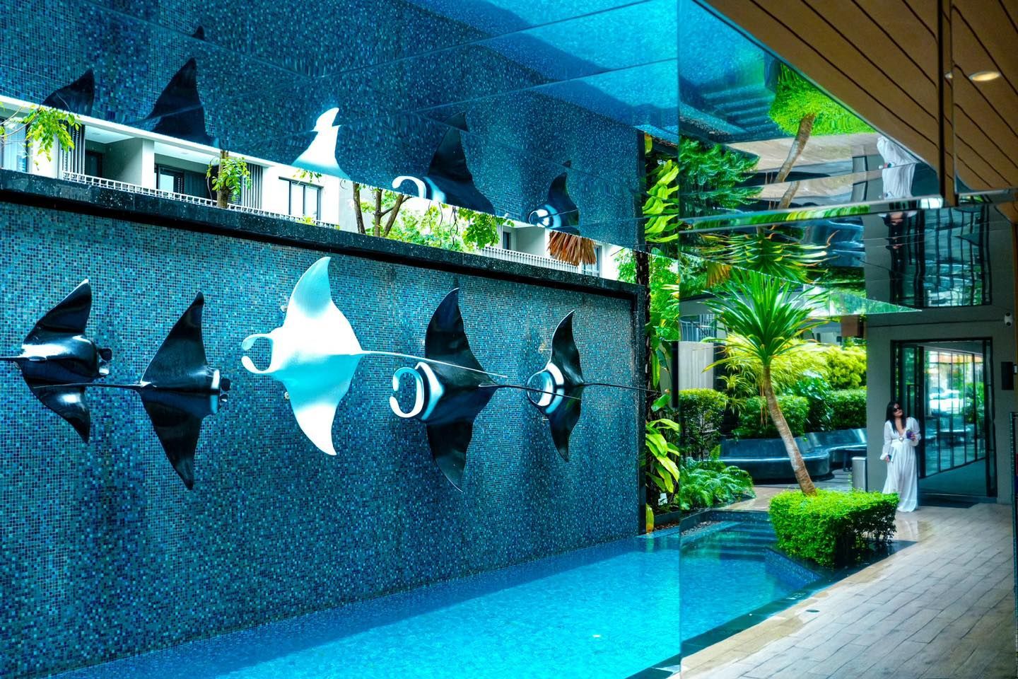 A swimming pool with a reflection of a manta ray in the water